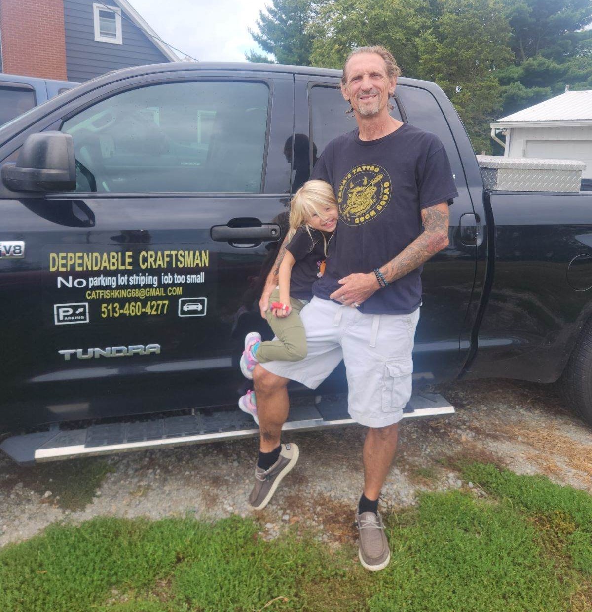 Dependable Craftsman owner standing beside work truck
