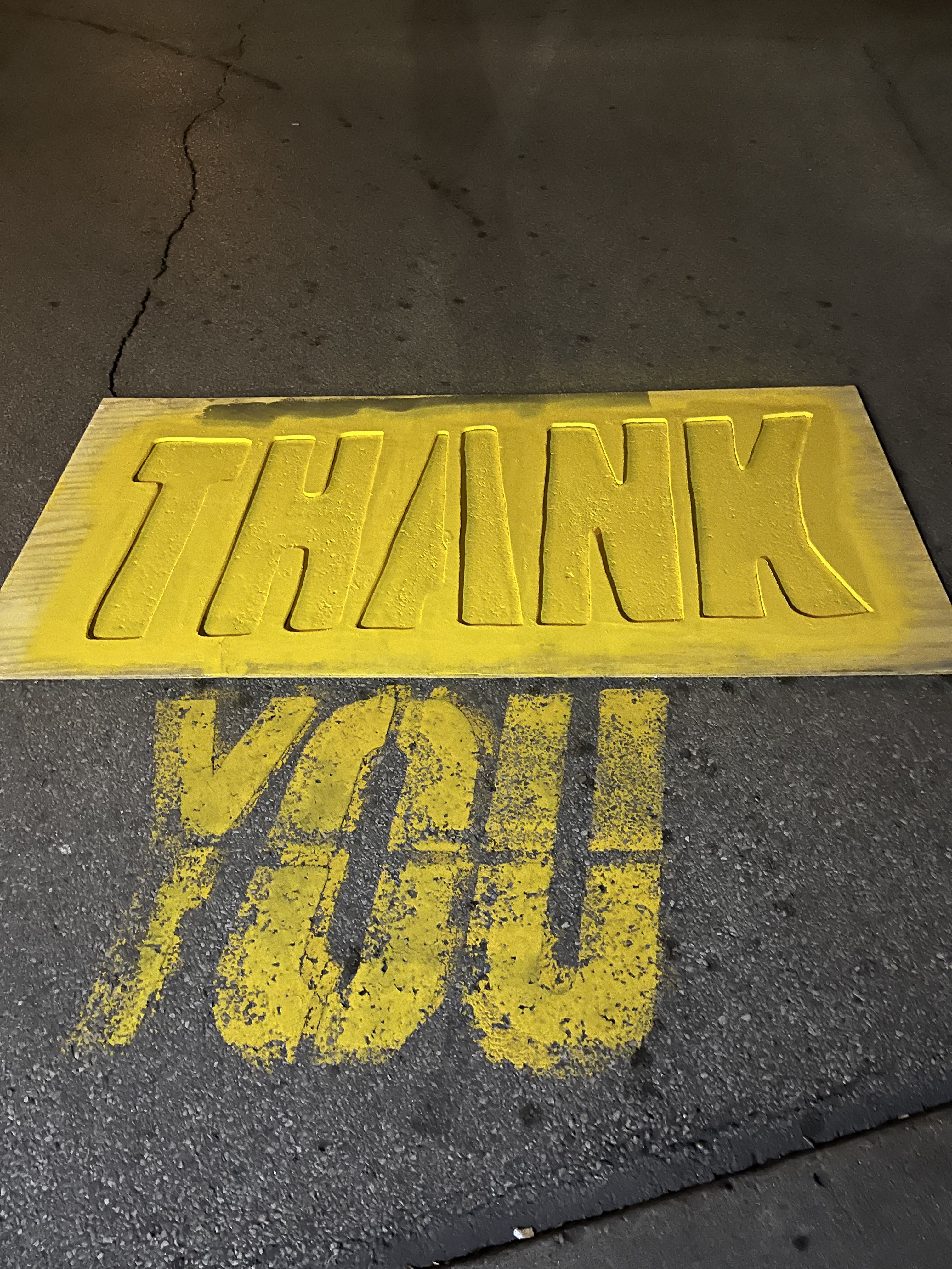 Fresh yellow stencil marking on pavement