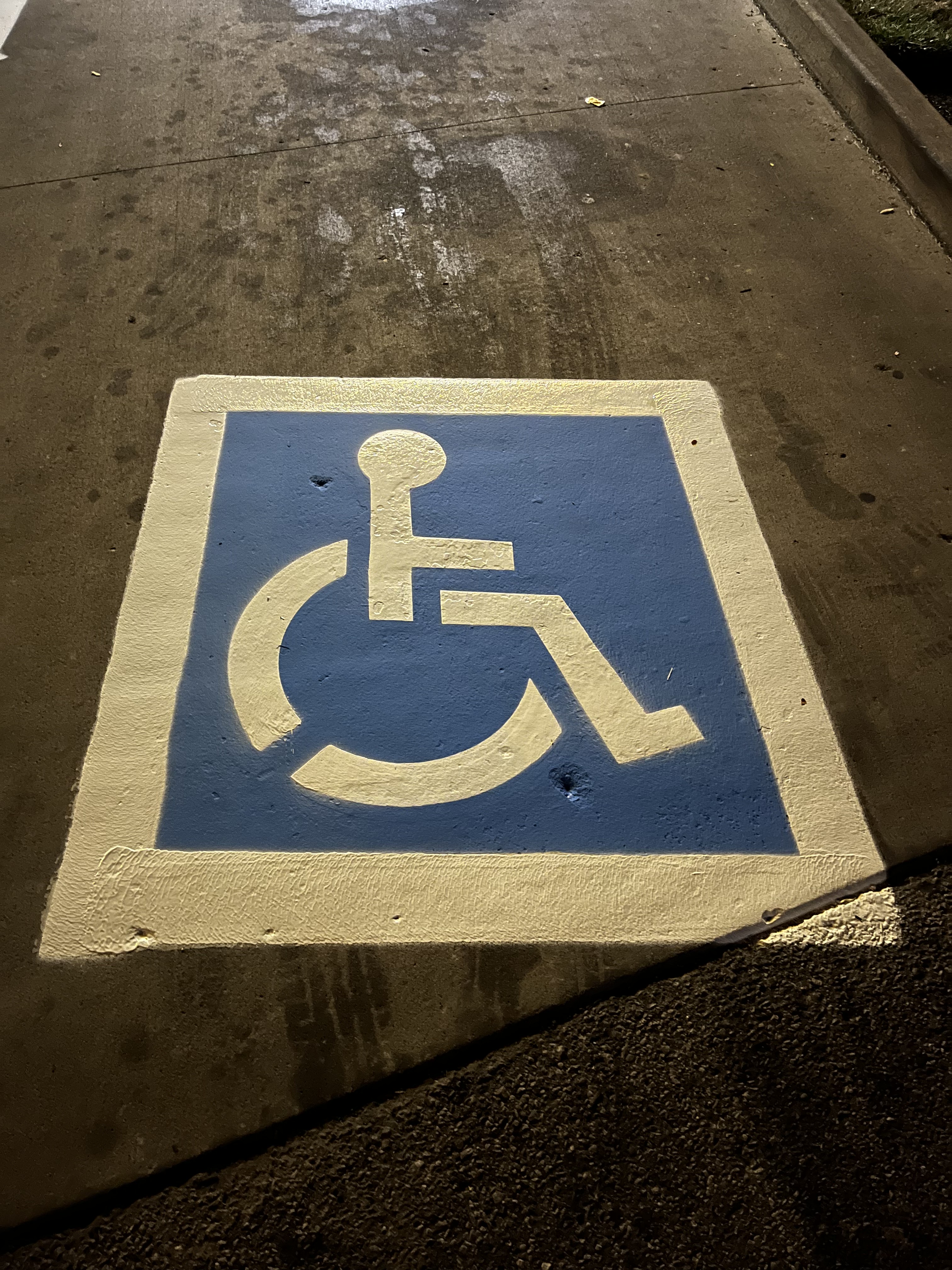 ADA accessible parking symbol painted on pavement
